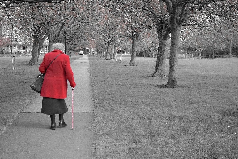 This shows an older lady taking a walk